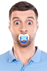 Cure Obstructive Sleep Apnea 37822667 - like a baby. funny young man with big eyes and pacifier in his mouth staring at camera while standing against white background