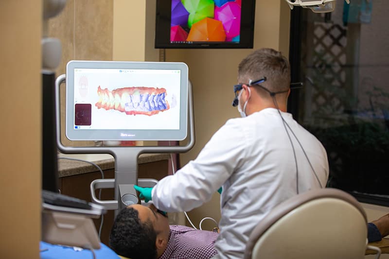 Cape Dental dentist performing bridge scan for a patient in need of dental bridges