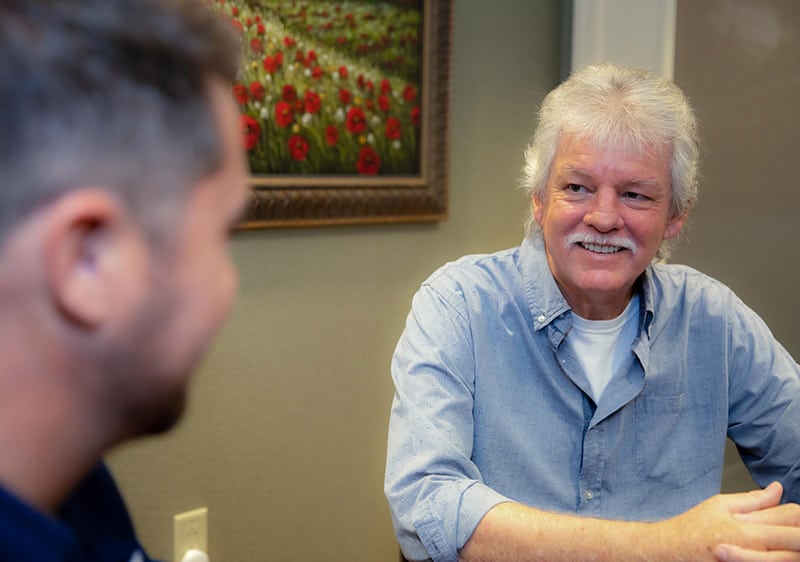 Patient smiling during consultation with Dr. Phillip Kraver at Cape Dental