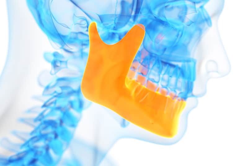 Animation of a x-ray of a patient's jaw with the lower jaw bone colored green