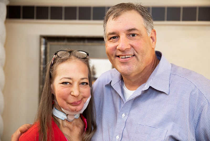 Patient smiling next to Dr. Kraver after he discovered her oral cancer, and which helped her find care and beat it