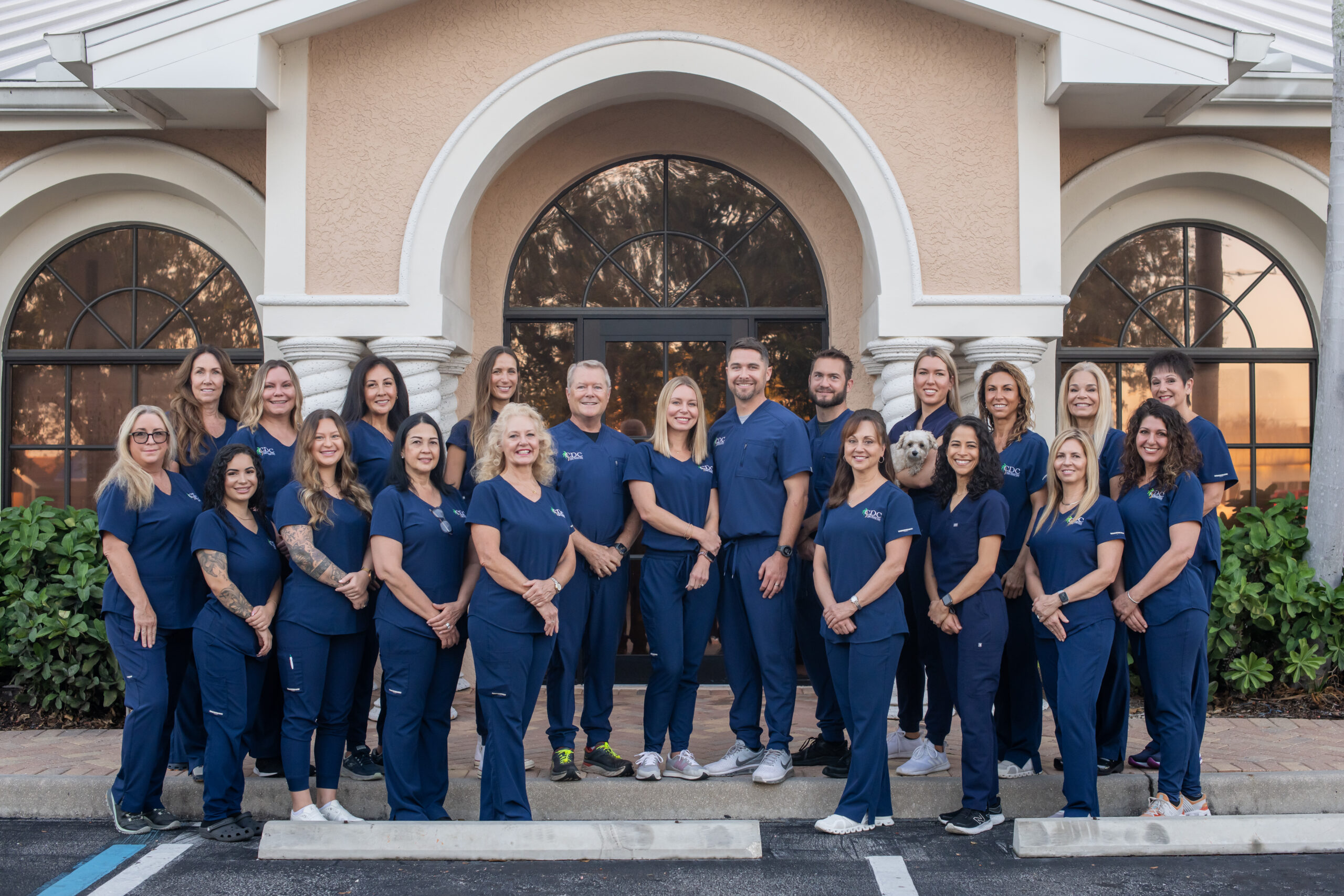 Cape Dental Care team smiling in front of their Cape Coral office
